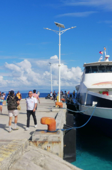 Travelers boarding a ferry at Siquijor port on a sunny day